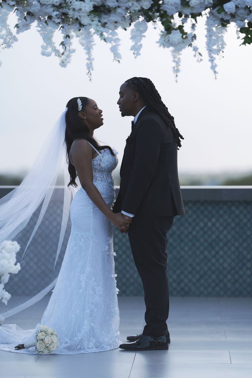 A romantic wedding sequence showing a couple in white dress and black suit dancing together on a light-colored floor.