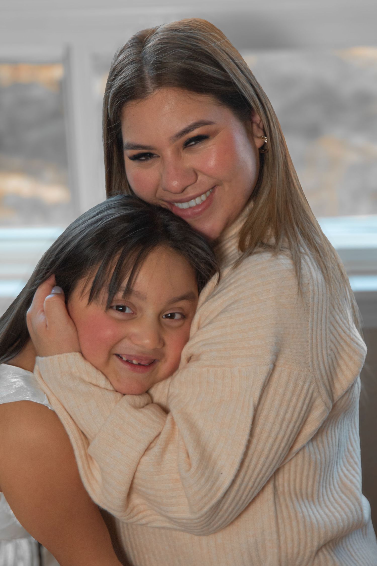 Two people share a warm embrace while smiling and wearing cozy sweaters in a series of candid moments.