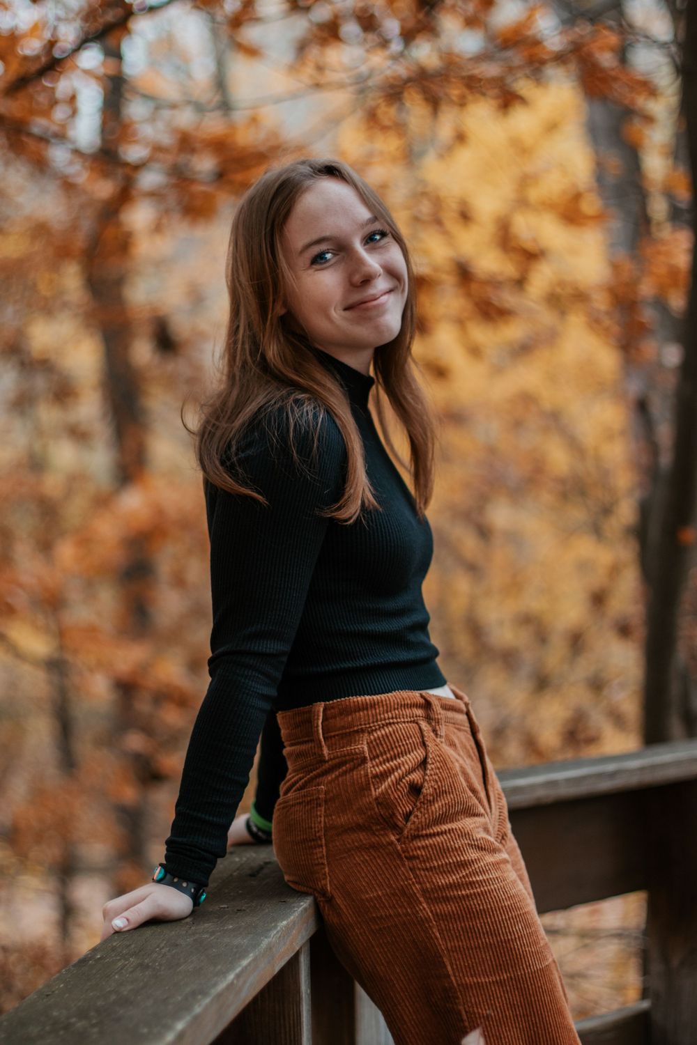 Portrait sequence showing relaxed poses against golden autumn trees and wooden railing.