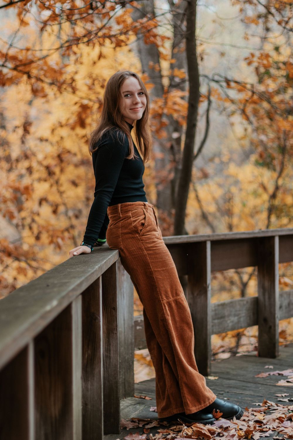Outdoor photography series featuring brown corduroy pants and black top against autumn scenery.