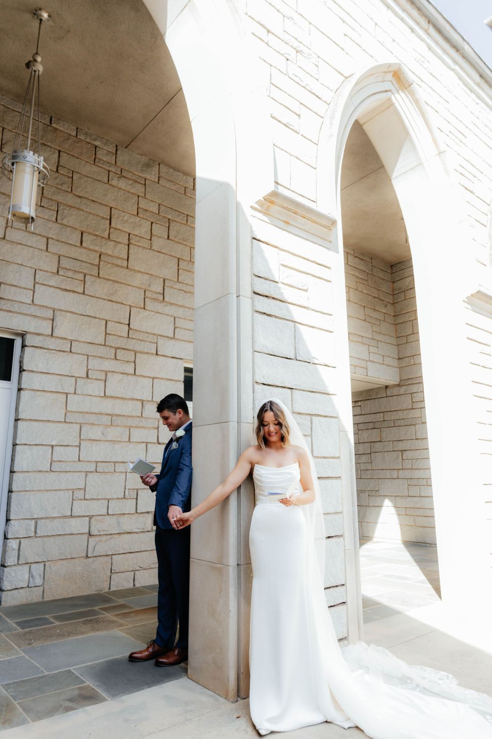 A sequence of five wedding photos showing a couple sharing a first look moment in an elegant stone archway.