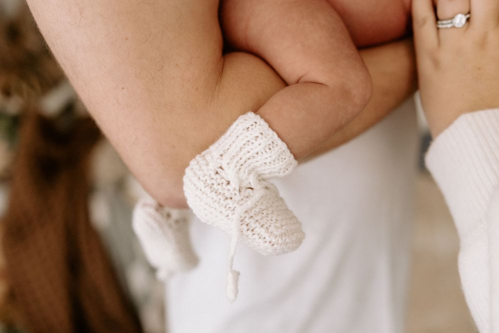 A close-up of hands exchanging wedding rings during an intimate ceremony.