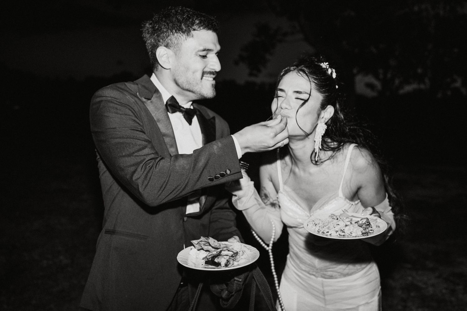 A series of wedding cake feeding moments captured in black and white photography.