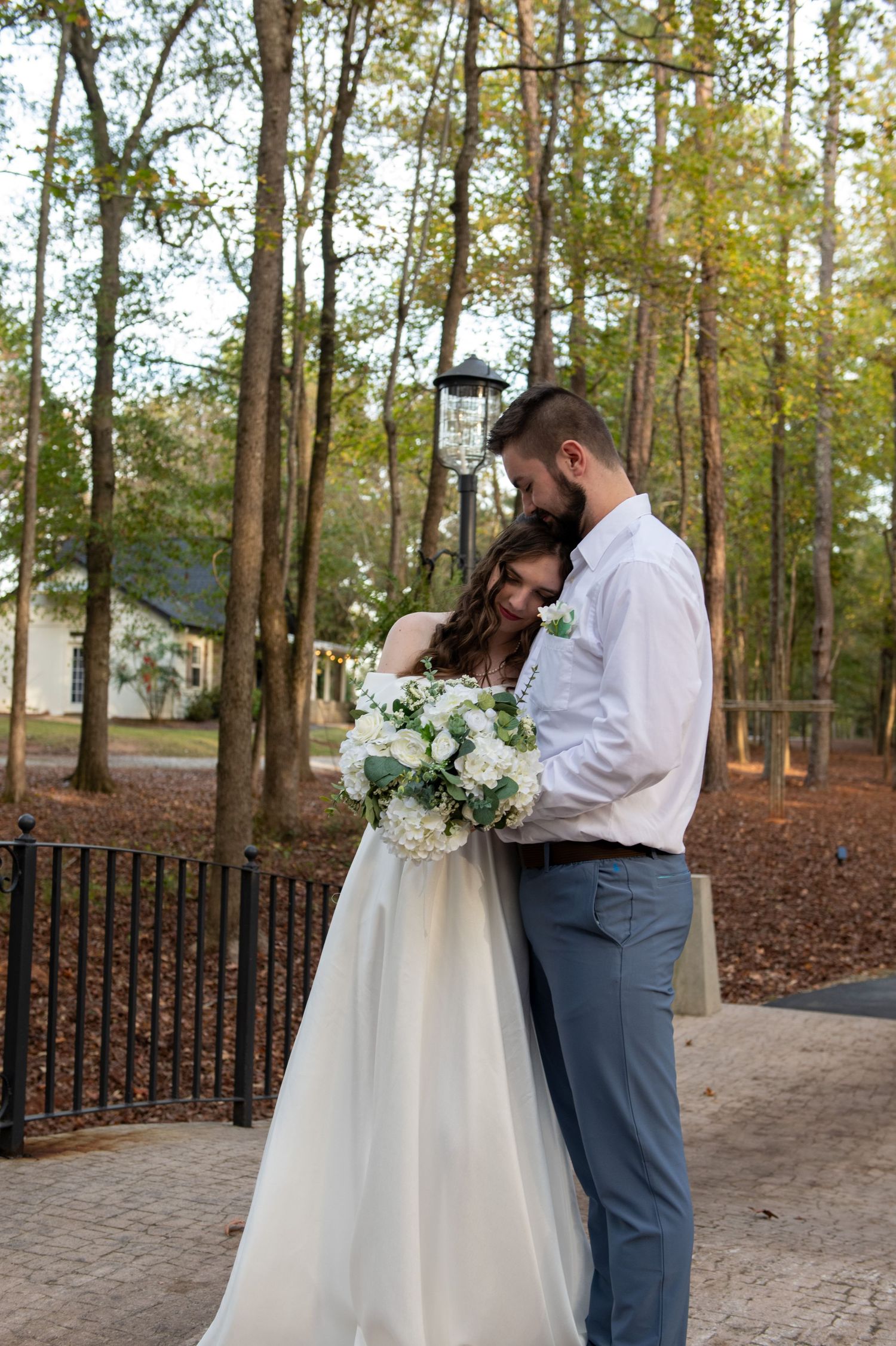 In love couple taking wedding portraits on dreamy bridge at Sanctuaire Atelier.