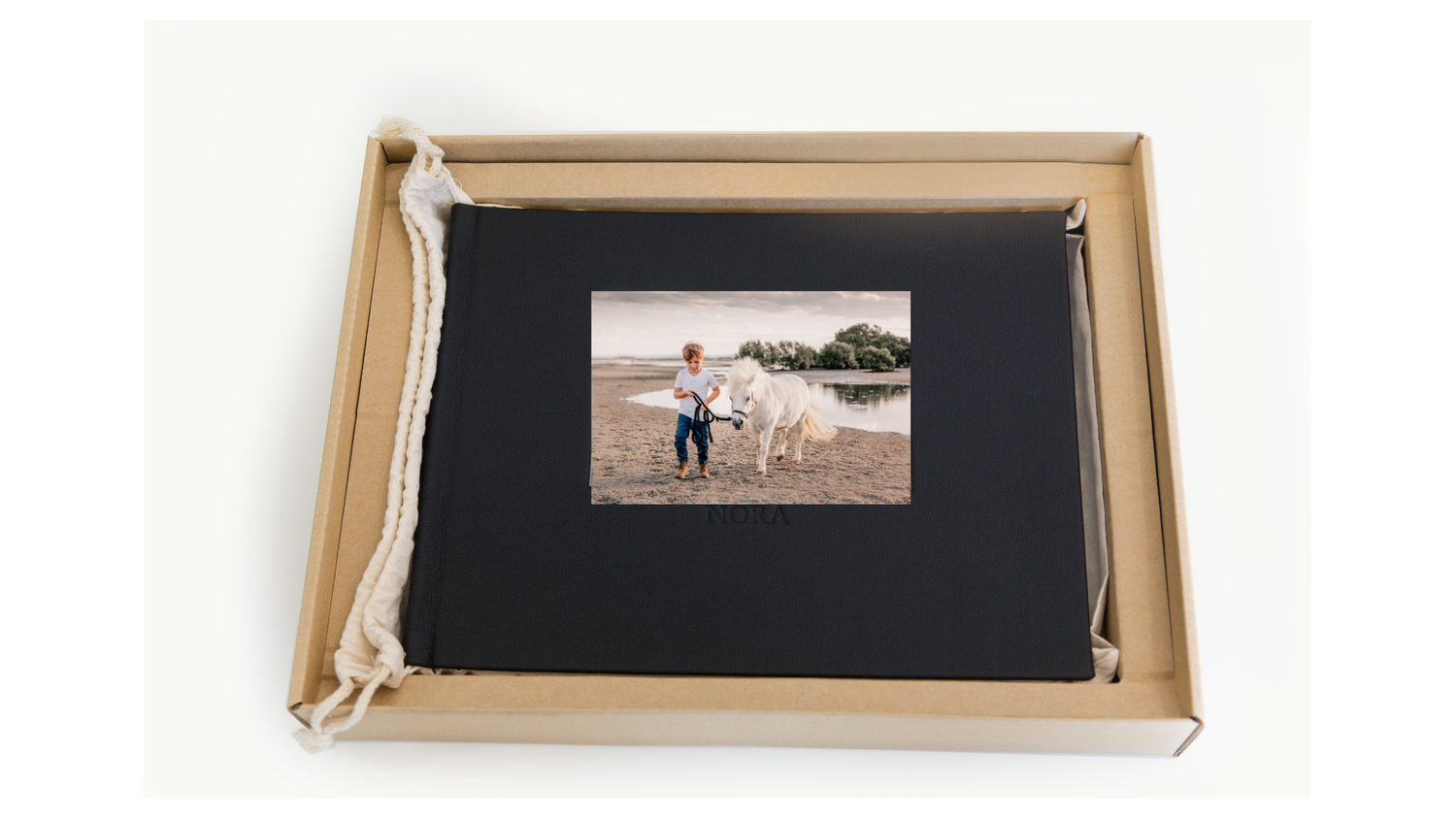 Wooden frame box with black matting displayed on white surface.