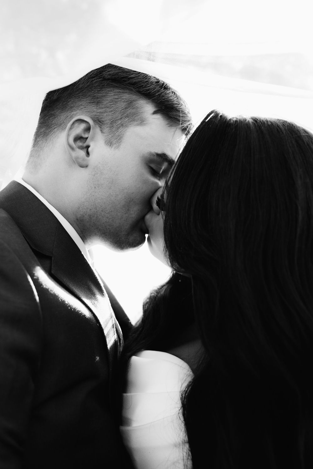 Romantic black and white close-up sequence of couple sharing intimate kiss.