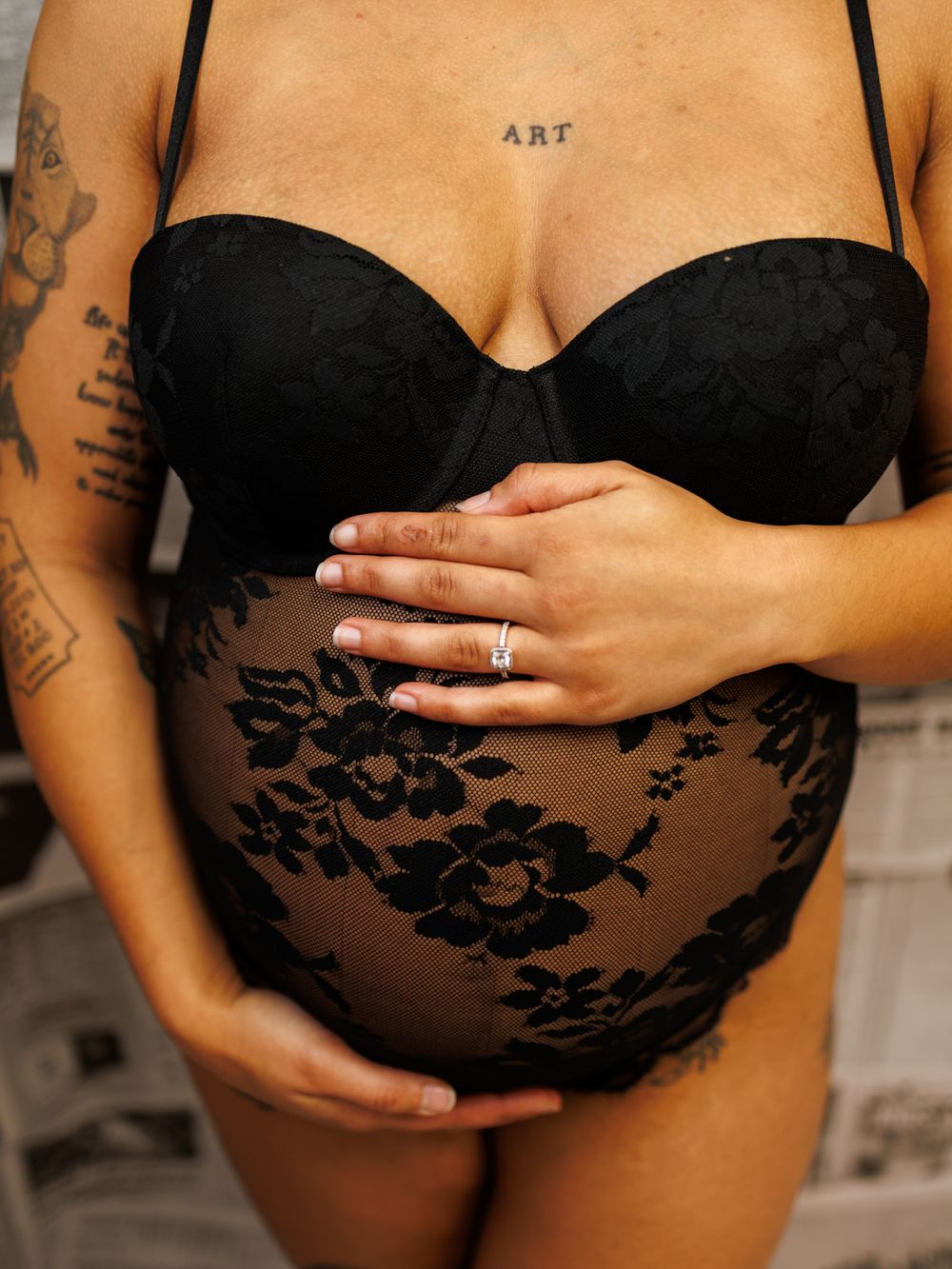 Close-up photo of a black lace maternity boudoir lingerie set against a light background.
