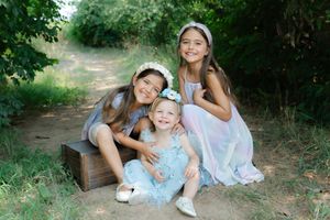 Outdoor portrait of three sisters in a secret garden setting