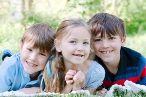 Candid facial close-up portrait of two brothers and one sister