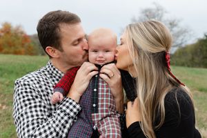 Mom and dad kissing their babies during a candid family photo session