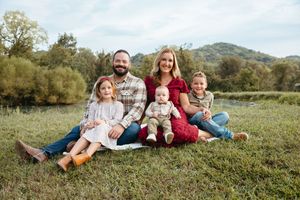 Family sitting on grass during an outdoor family photo session