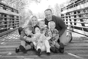 Family snuggling and laughing together during a playful outdoor family photo session