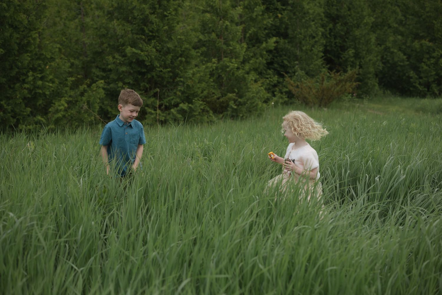 Children playing together in a lush green field