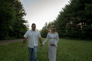 A couple shares a tender moment together in a serene outdoor setting.