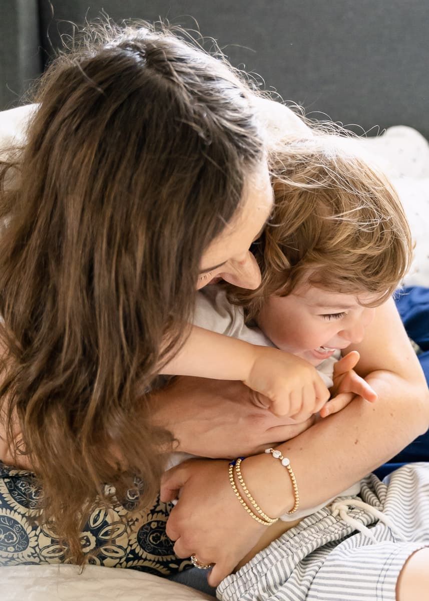 A heartwarming moment shows a close embrace and kiss in a sweet display of affection at lifestyle family session