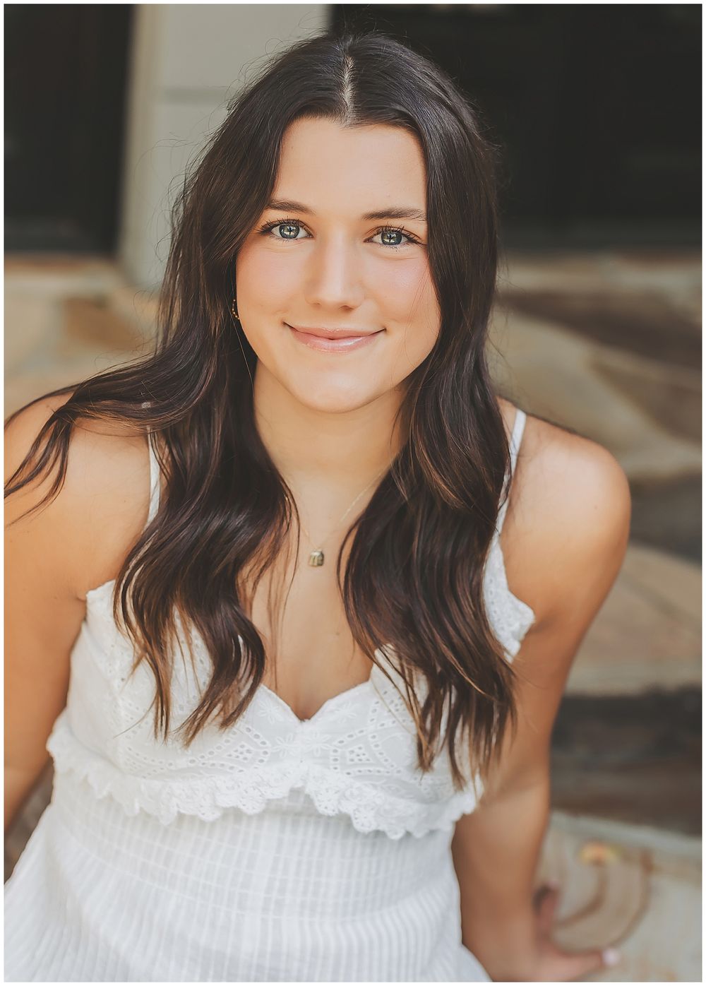 Portrait series in white eyelet top against neutral backdrop.