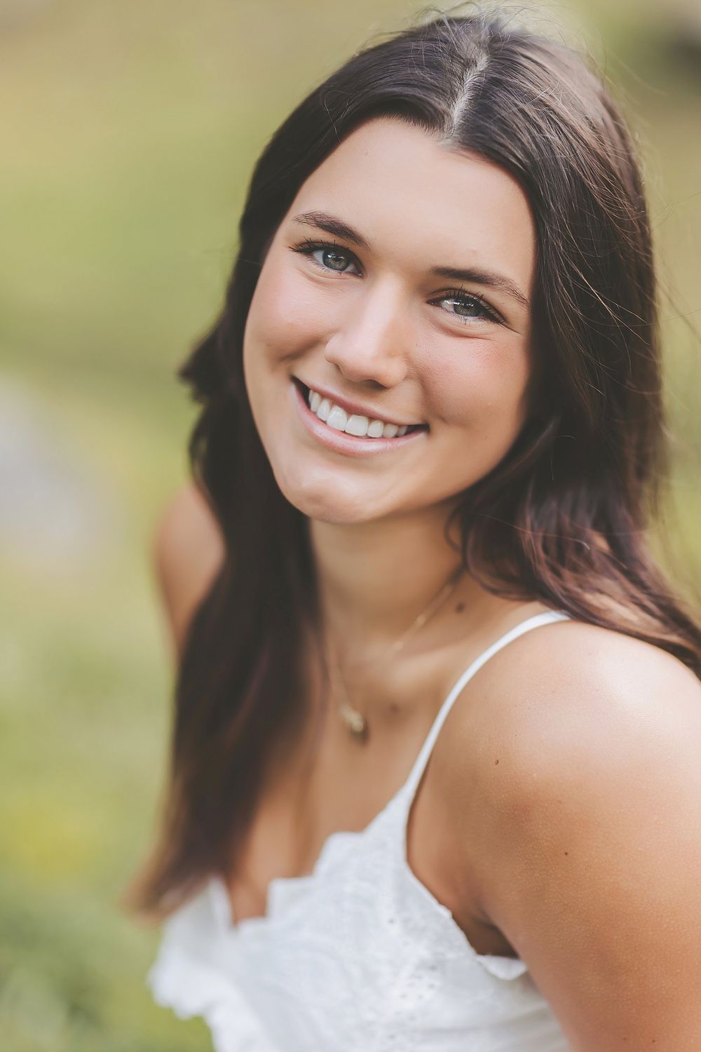 Close-up portrait sequence showing genuine laughter and happiness in an outdoor setting.