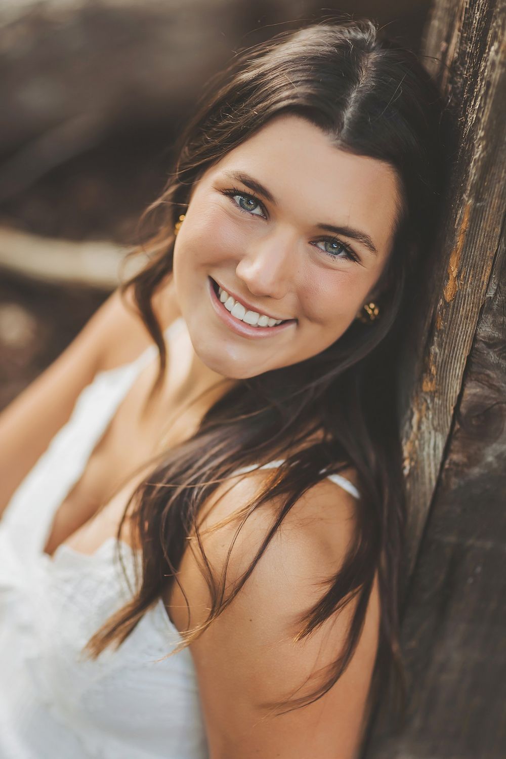 Close-up portraits with bright expressions against rustic wooden background.