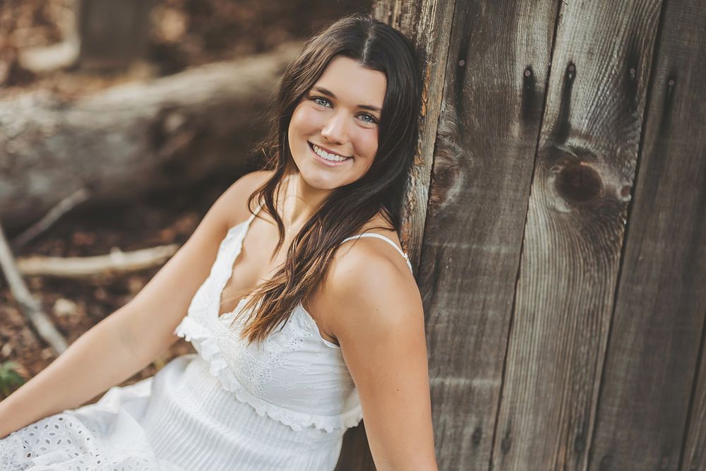 Casual outdoor portrait series featuring white summer dress and natural lighting.