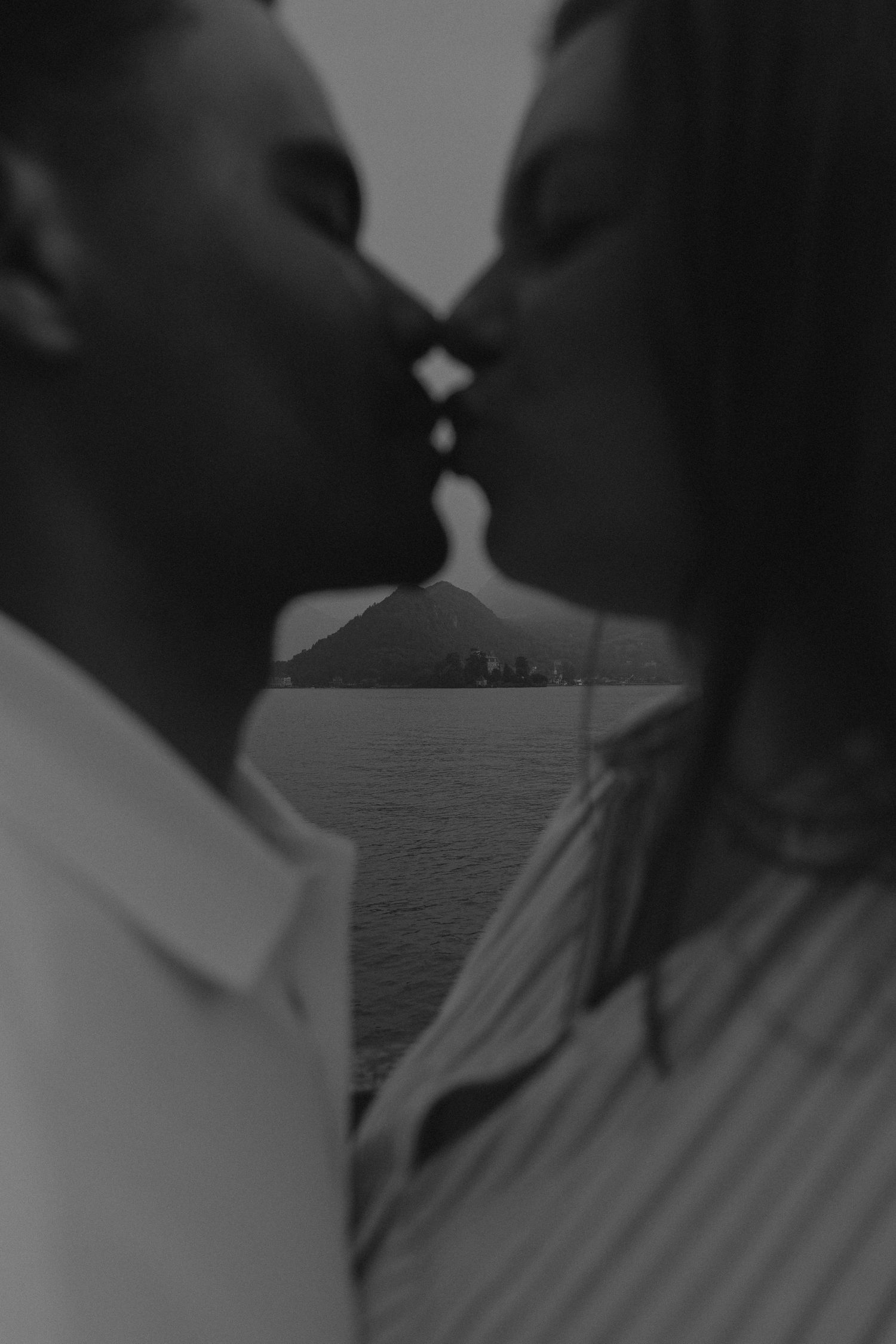 A silhouetted couple shares an intimate moment against a dark background.