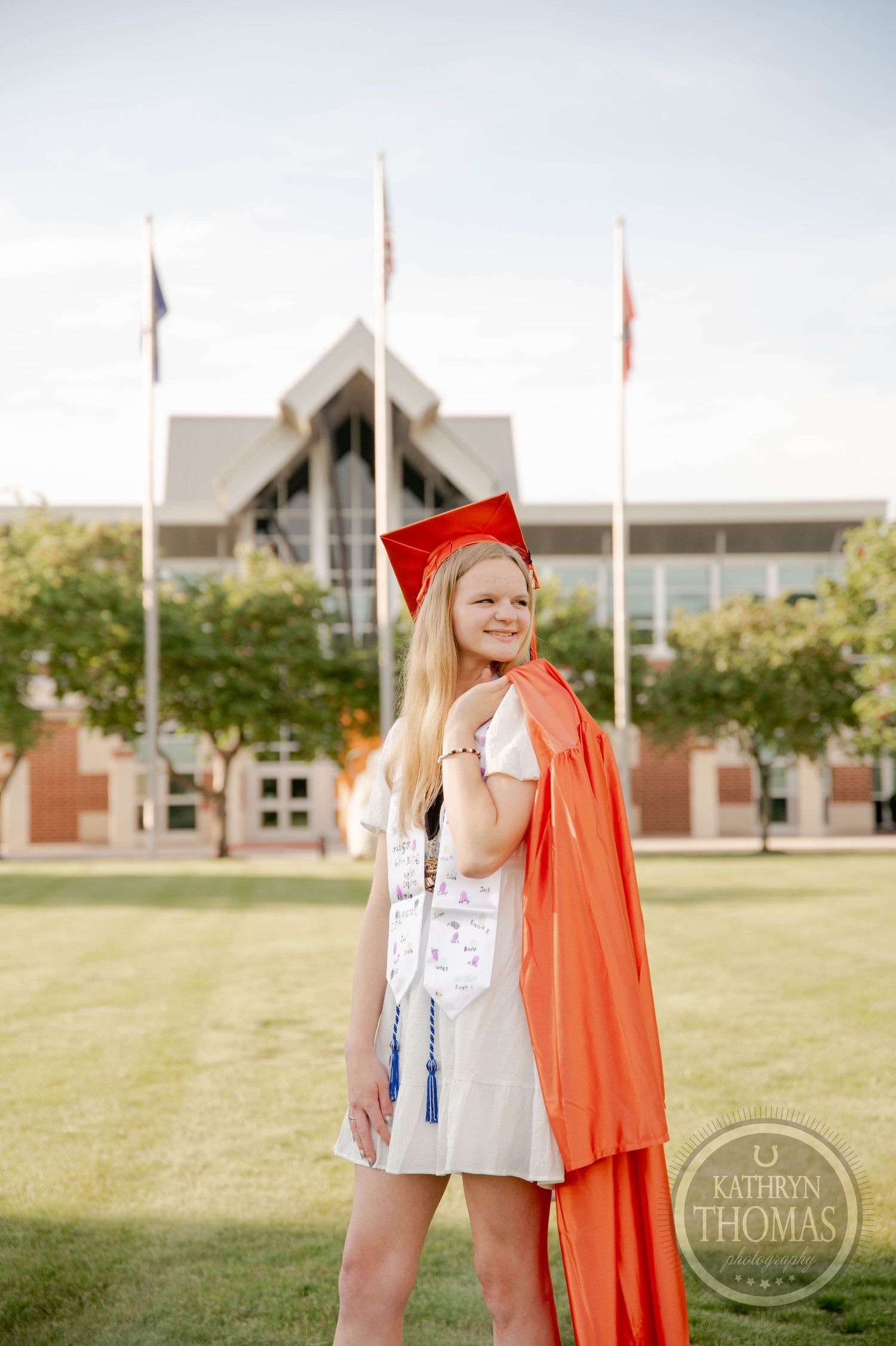 Four connected photos showing a young graduate in orange cap and gown standing in front of campus buildings on a sunny day.