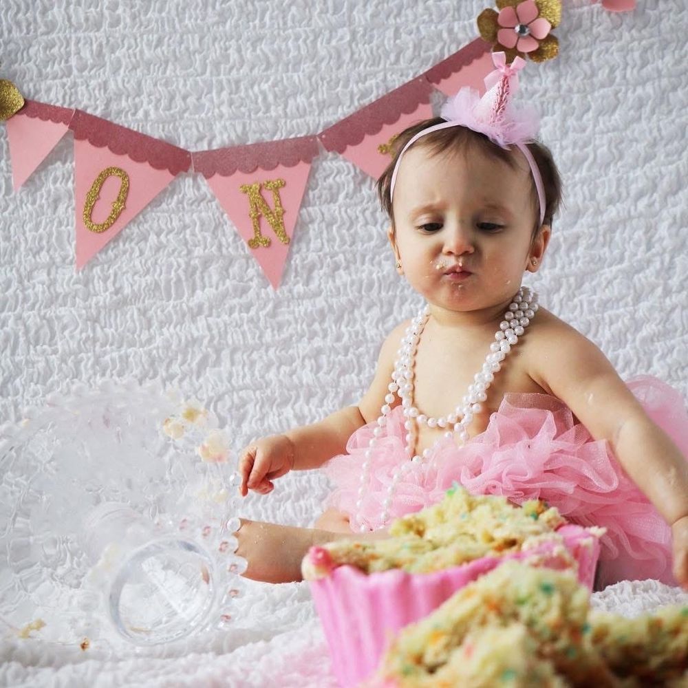 And she is 1! One-derful in a Winter One-derland! How many puns can we make? She is as sweet as that cake...don't let her face fool you.