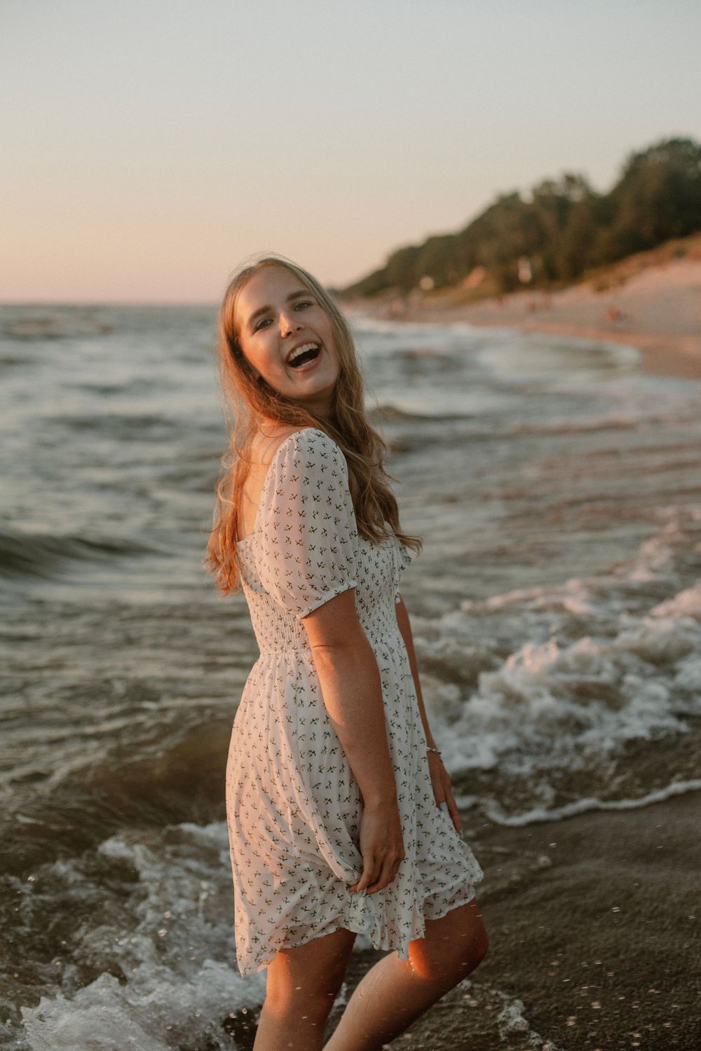 Senior girl at a beach sunset photo session in Holland, MI in front of Lake Michigan.