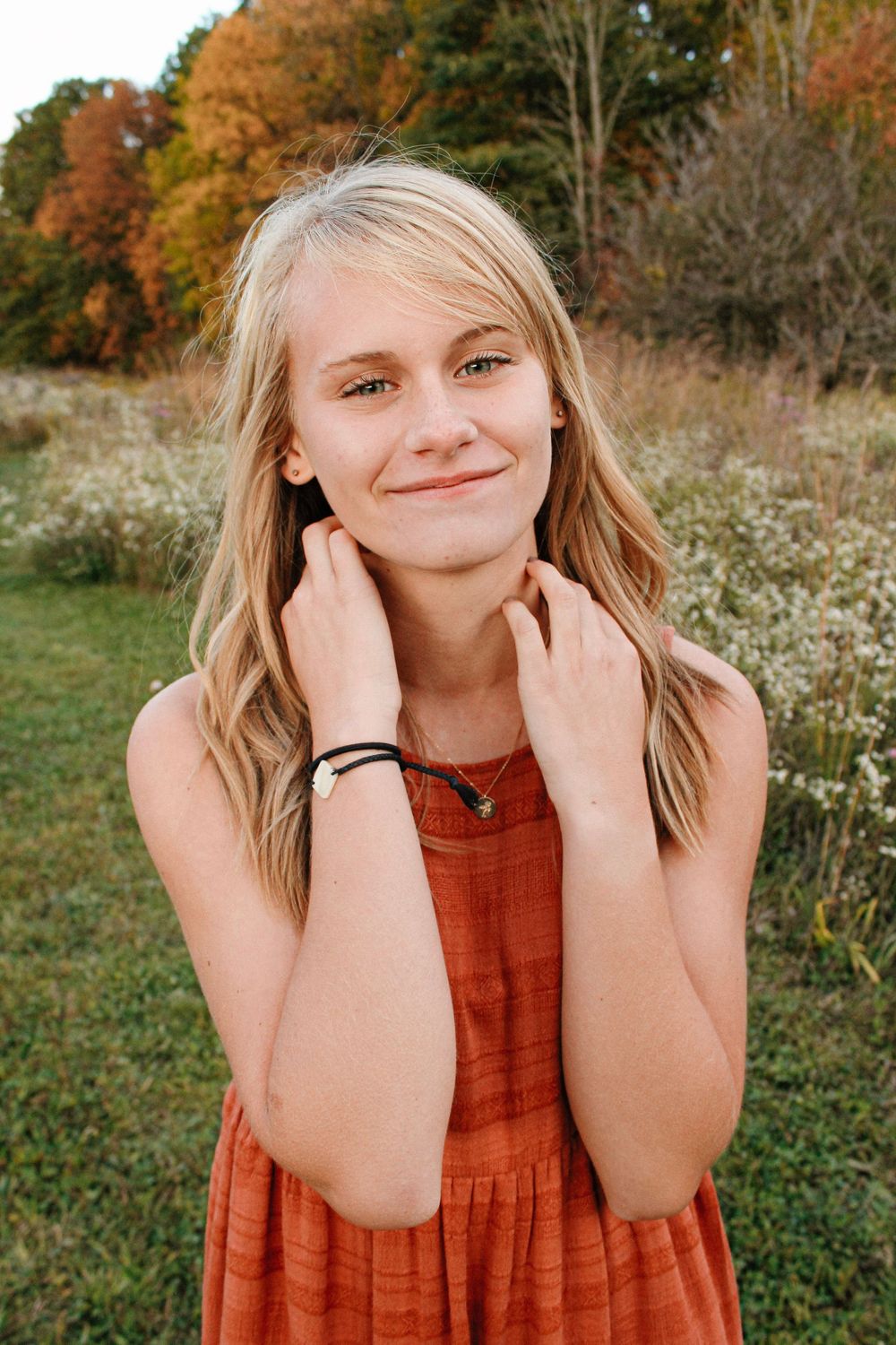 Senior girl in a field during golden hour at Grand Ravines Park.