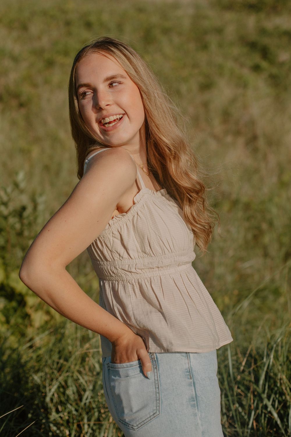 Senior girl at a beach sunset photo session in Holland, MI.