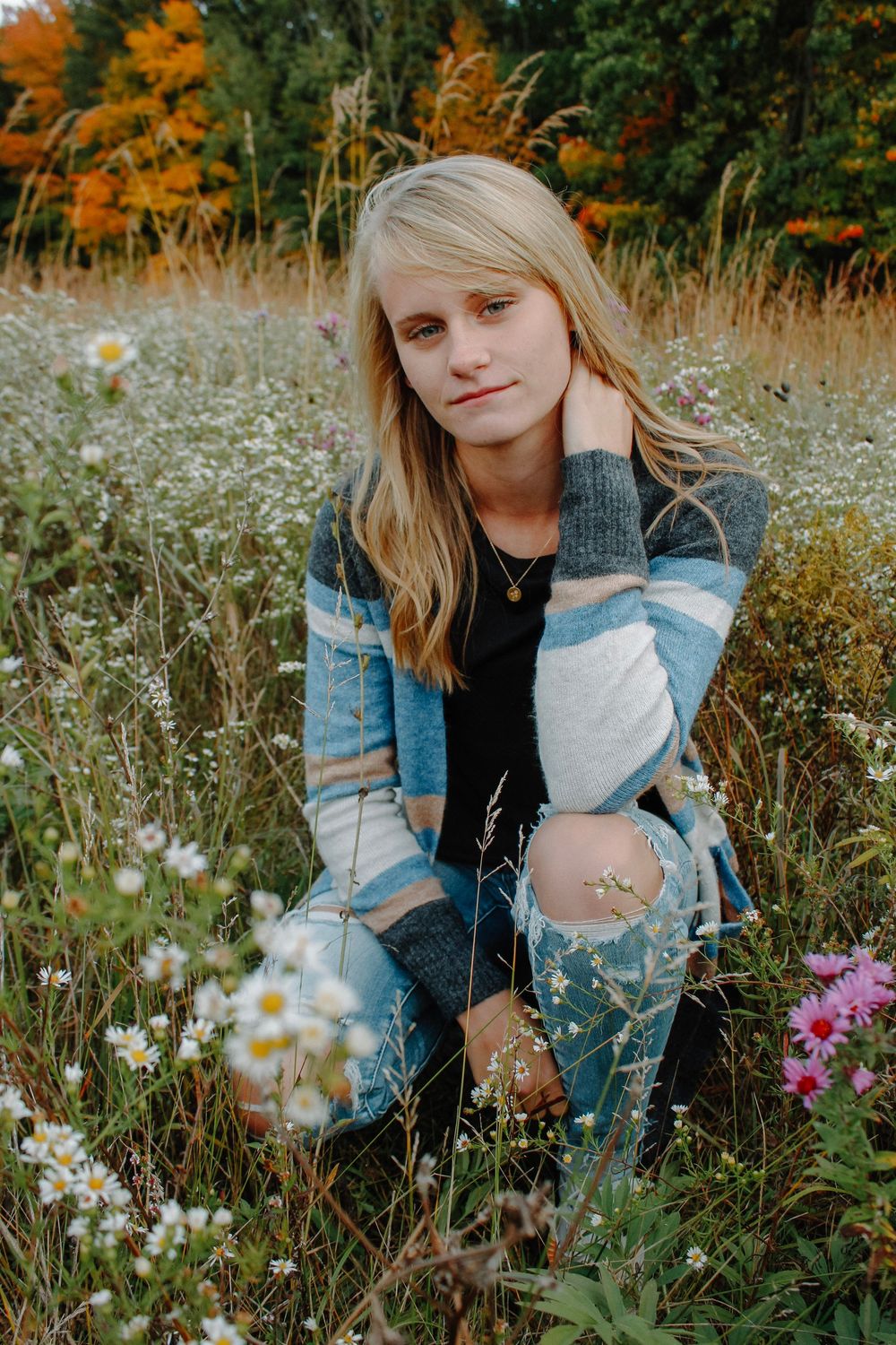 Senior girl in a field during golden hour at Grand Ravines Park.