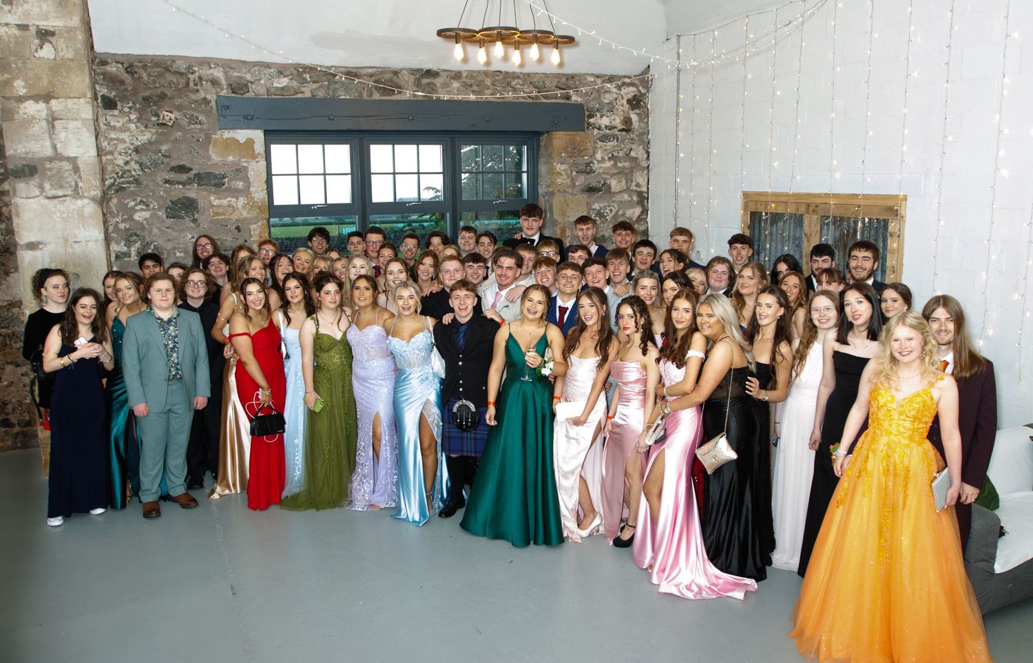 A group photo series of people in formal attire lined up for prom or formal event photos.