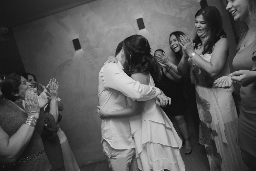 Black and white photo of dancing and celebration at a wedding reception.