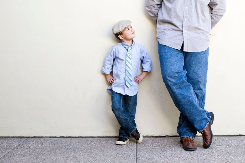Portrait of a young boy looking up at this father