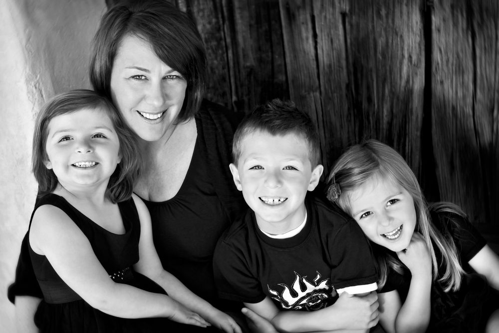 mom and three children smiling in a family photo by portrait photographer Wondertime Photography