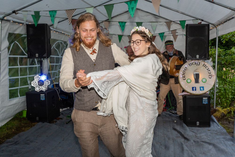 A newly married couple having their first dance in a marquee at their pagan wedding.