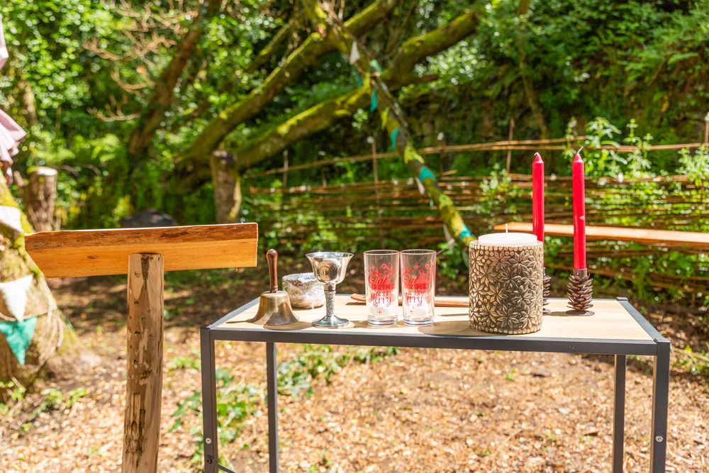 An altar set up in a woodland glade ready for a pagan handfasting ceremony.