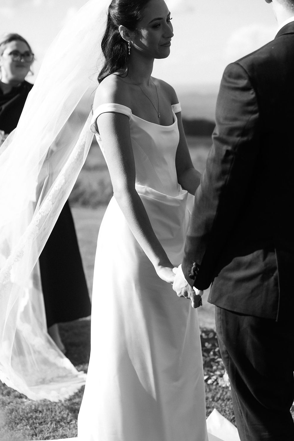 Close-up black and white detail shots of formal wedding attire and veil movement.