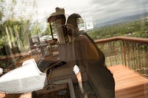 Blurred artistic photograph of camera equipment on an outdoor deck with mountain views.
