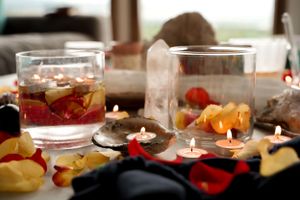 Decorative table setting with candles, fruit, and drinks for a special celebration.
