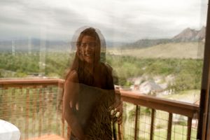 Double exposure photograph showing a mountain landscape through glass windows.