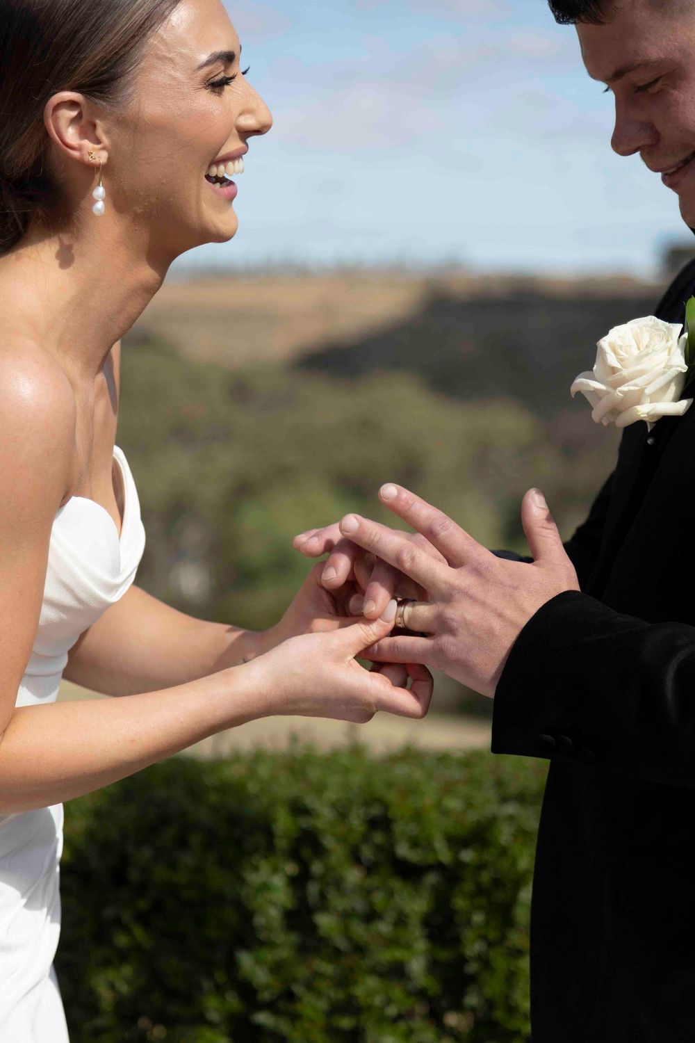 Bride and groom exchanging vows with panoramic valley scenery in background