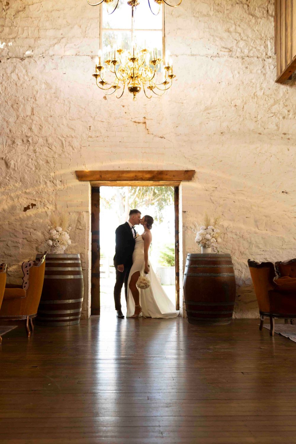 Wedding couple kissing with panoramic  backdrop at Warrawong Estate in Victoria