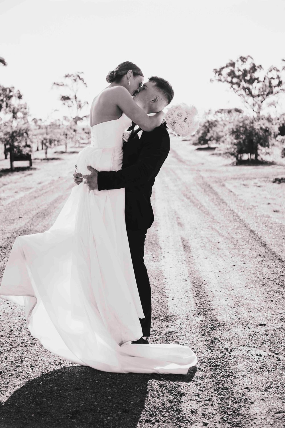 Bride and groom embracing at sunset with sweeping valley views at Warrawong Estate Victoria