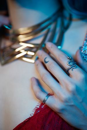 Close-up of hands writing in blue lighting creating an ethereal artistic composition.