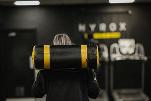 Black and yellow exercise equipment in a dimly lit fitness center.