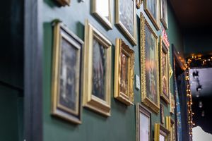 Art gallery wall with framed paintings and soft lighting creating an elegant display.