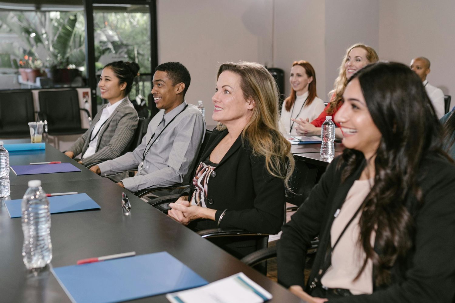 Business professionals sit attentively in a conference room during a presentation.
