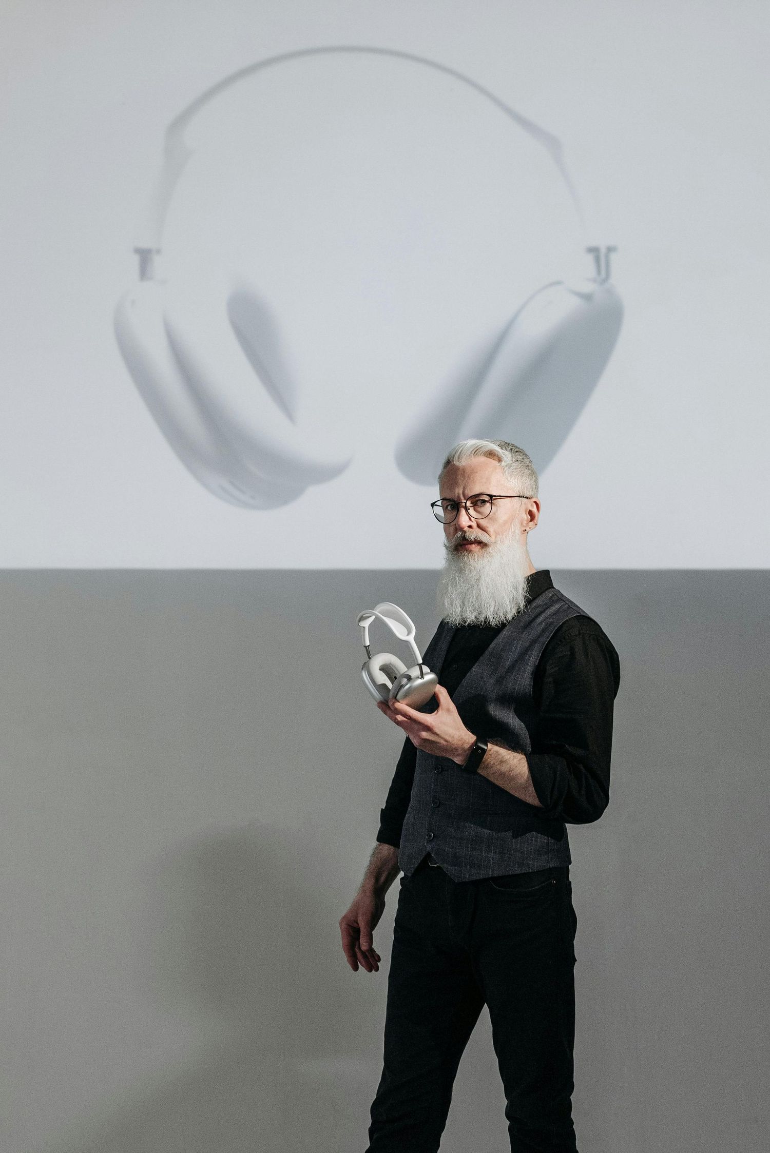 A sequence of photos showing a person in black clothing making shadow puppets against a white wall.