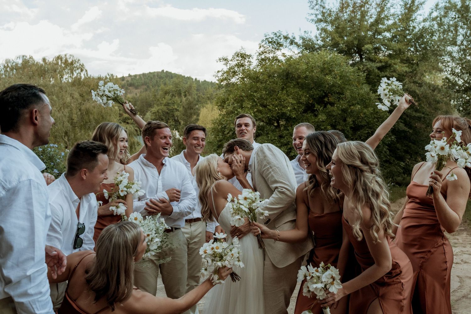 A joyful celebration on a black and white checkered dance floor at a wedding reception.