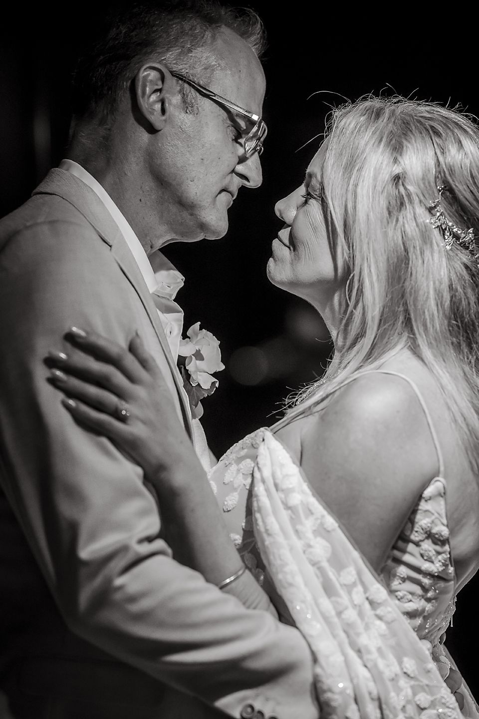 Black and white sequence captures intimate dance between newlyweds during wedding reception.